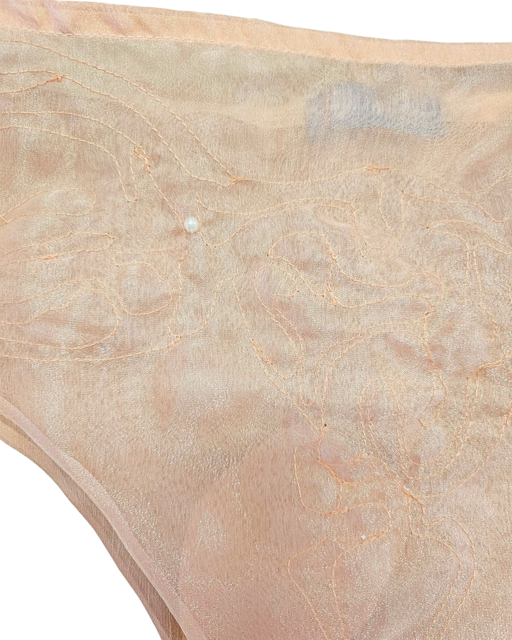 Close-up of beige fabric with a subtle pattern on a white background