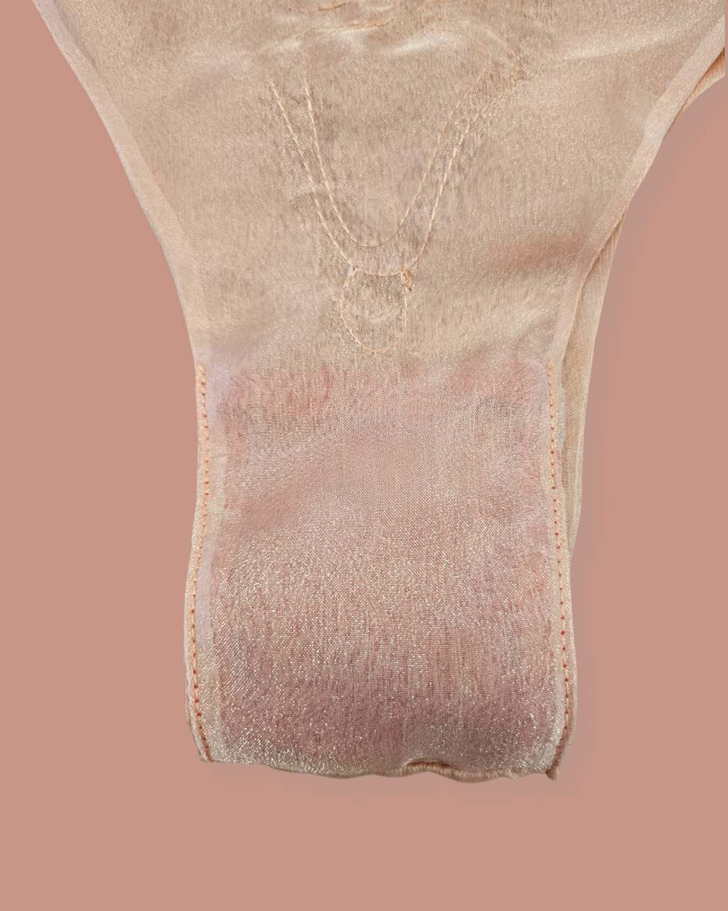 Close-up of a beige insole on a pink background